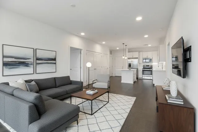 a view of a kitchen with a refrigerator and a stove top oven