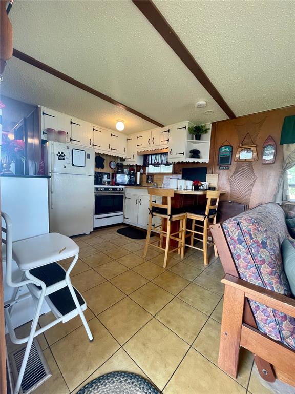641 Sky Camp Loop, Unit 2 Graford, TX 76449 - Photo 11 of 29 a dining room with lots of furniture and clutter