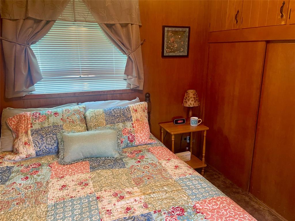 641 Sky Camp Loop, Unit 2 Graford, TX 76449 - Photo 14 of 29 a bedroom with a bed and a table