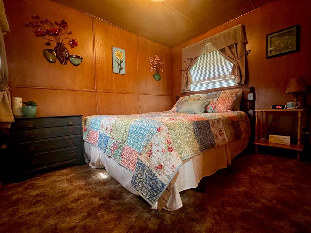 641 Sky Camp Loop, Unit 2 Graford, TX 76449 - Photo 15 of 29 a bed sitting in a bedroom next to a window