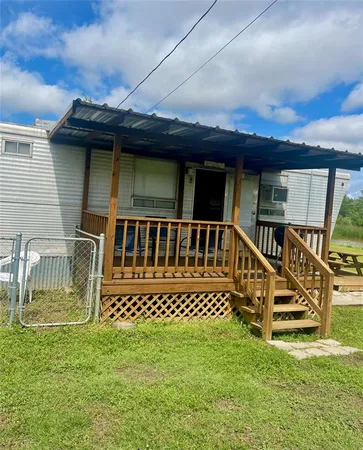 a view of a house with a wooden deck