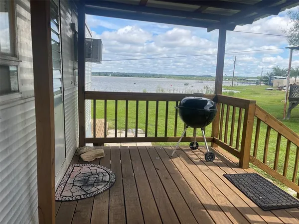 a view of balcony with wooden floor and iron fence