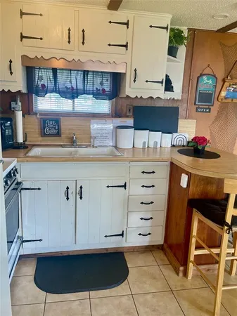 a kitchen with a cabinets and wooden floor
