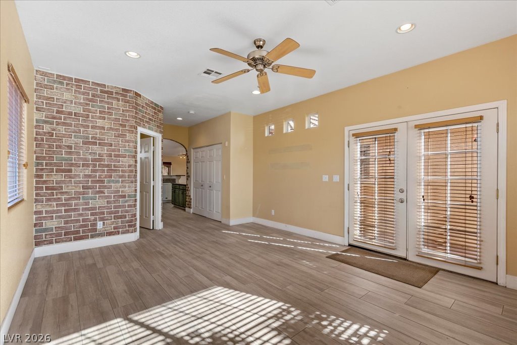 120 Ringlore Road Henderson, NV 89015 - Photo 7 of 58 An exposed brick feature wall and glass doors highlight this versatile living space.
