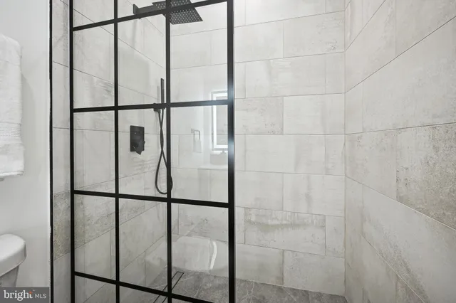 a bathroom with a glass shower door