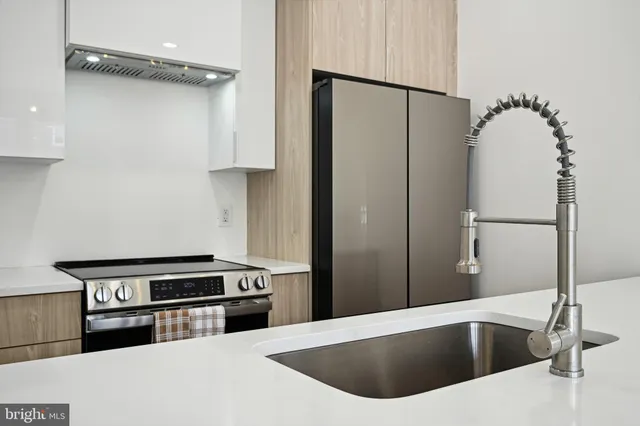 a kitchen with a refrigerator and a sink