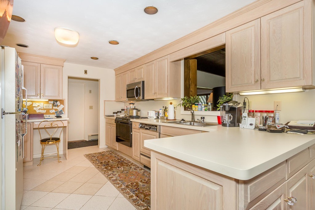6 Wentworth Road Canton, MA 02021 - Photo 3 of 16 a kitchen with a sink a stove and cabinets