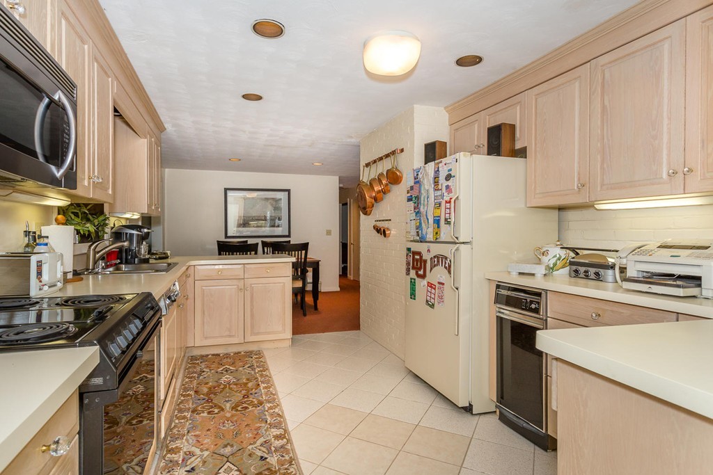 6 Wentworth Road Canton, MA 02021 - Photo 4 of 16 a kitchen with a refrigerator a stove top oven a sink and white cabinets