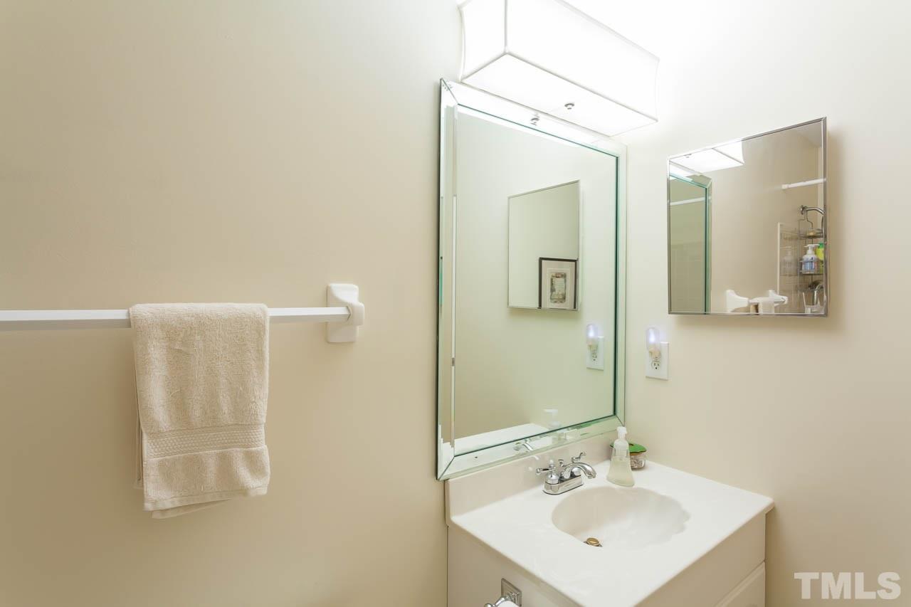 2013 Broadingham Court Raleigh, NC 27615 - Photo 15 of 21 a bathroom with a sink a mirror and shower