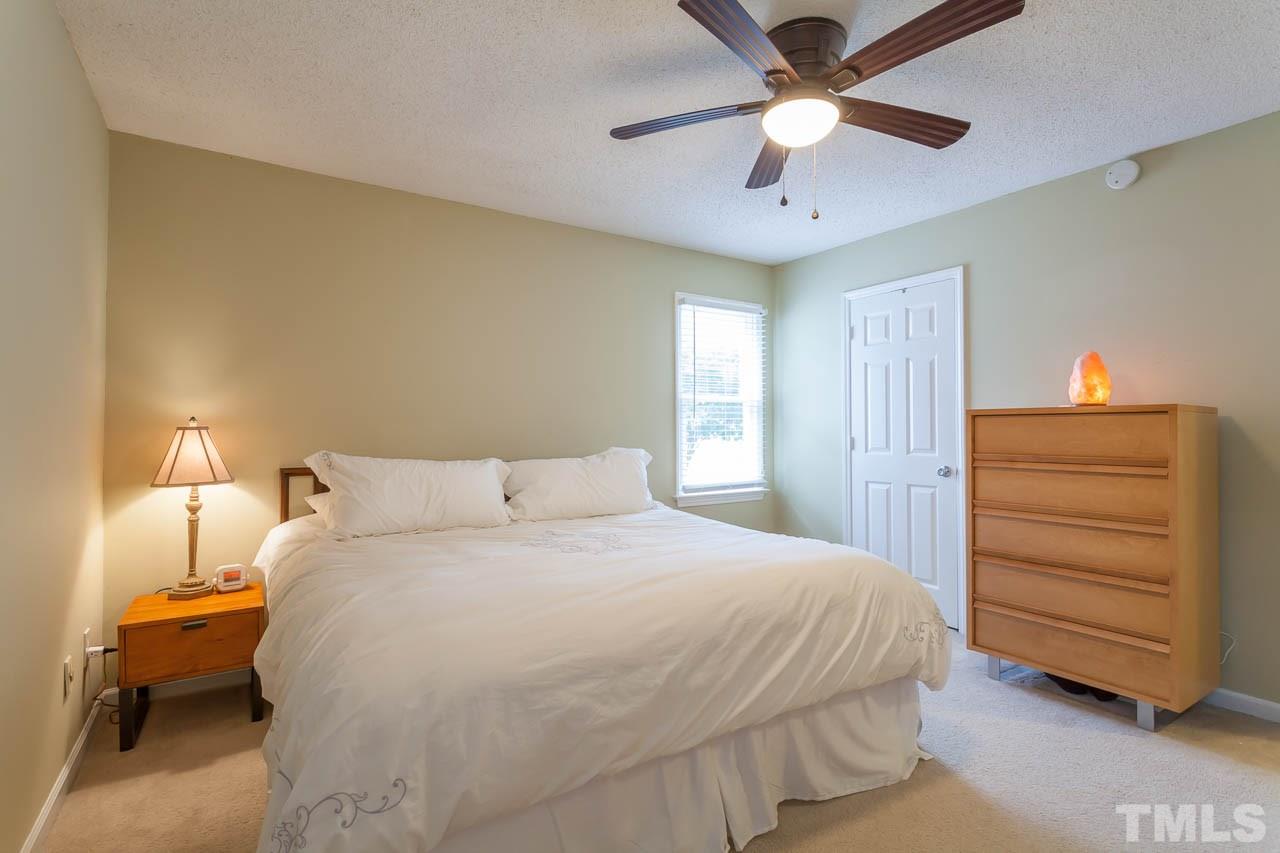2013 Broadingham Court Raleigh, NC 27615 - Photo 16 of 21 a bedroom with a bed and a ceiling fan