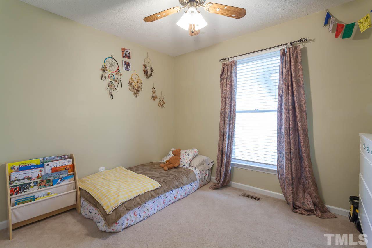 2013 Broadingham Court Raleigh, NC 27615 - Photo 17 of 21 a bedroom with a bed and a window