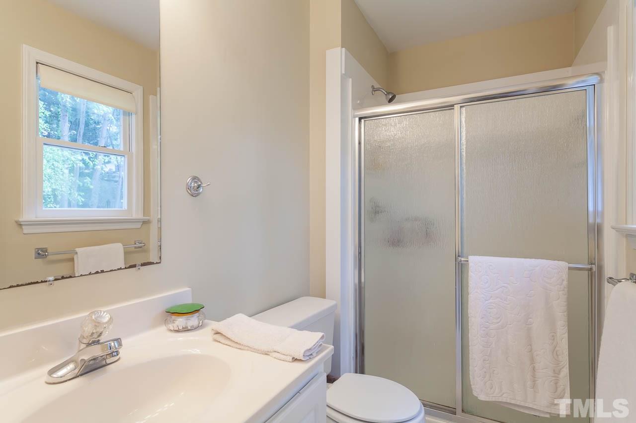 2013 Broadingham Court Raleigh, NC 27615 - Photo 18 of 21 a bathroom with a sink toilet and shower