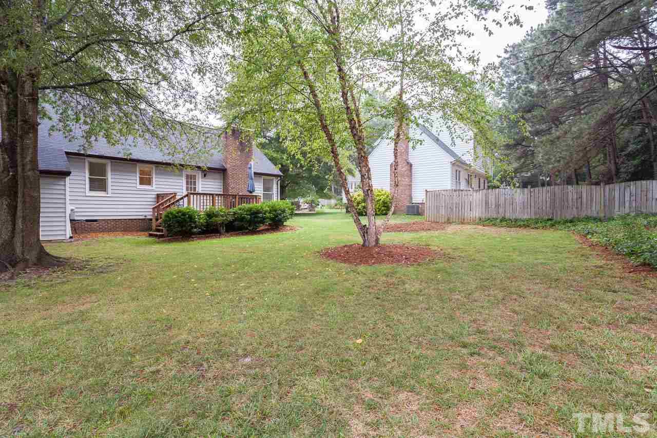 2013 Broadingham Court Raleigh, NC 27615 - Photo 20 of 21 a backyard of a house with lots of green space