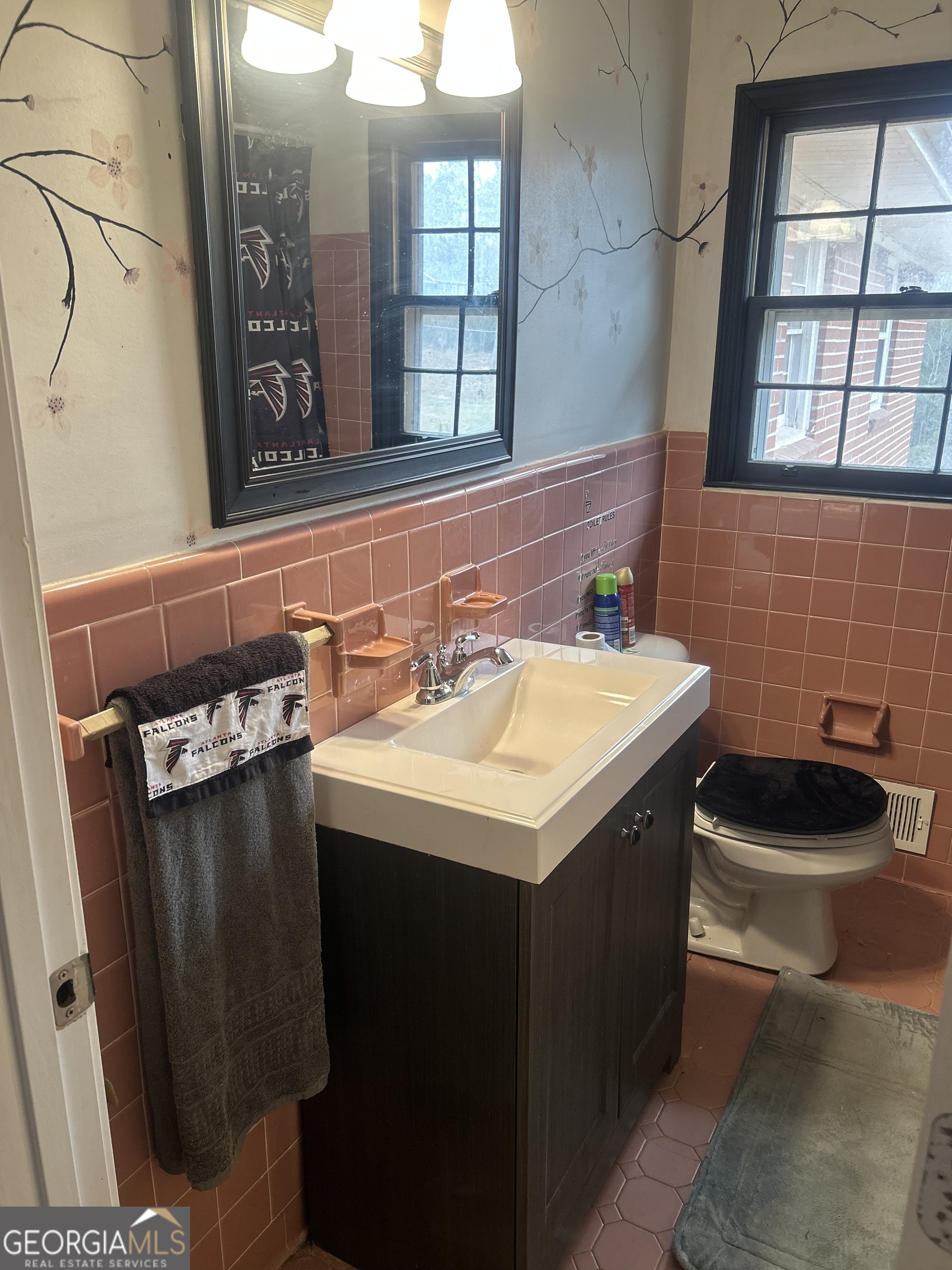 1406 Canterbury Road Griffin, GA 30223 - Photo 20 of 26 a bathroom with a sink and a mirror