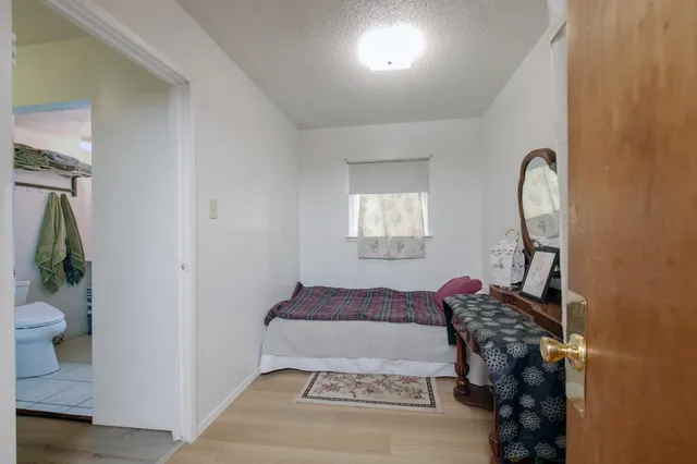 a bedroom with a bed and a potted plant