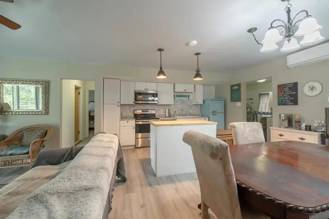 a large kitchen with a table and chairs