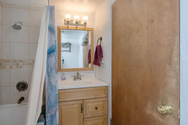 a bathroom with a sink vanity and mirror