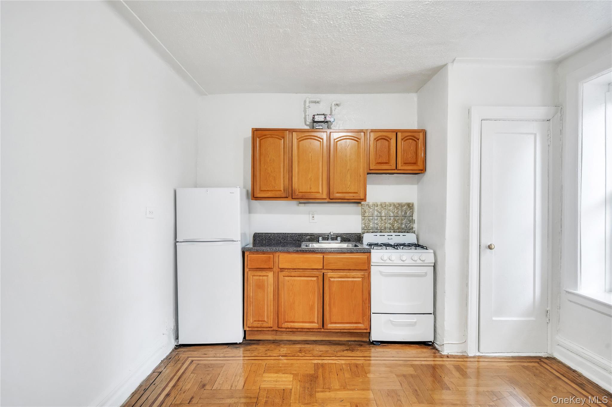 3152 Hull Avenue Bronx, NY 10467 - Photo 16 of 35 a kitchen with a refrigerator and a stove top oven