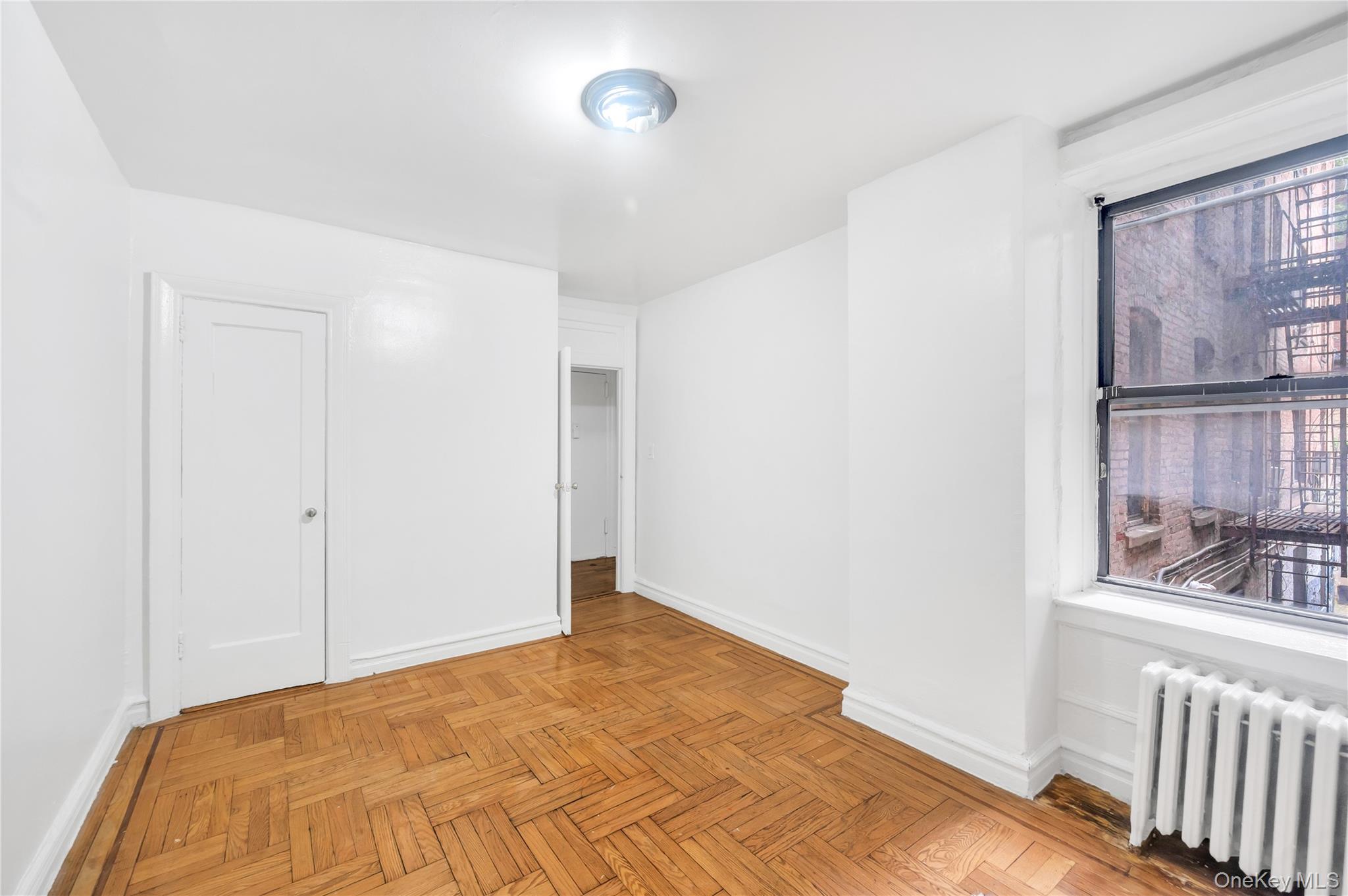 3152 Hull Avenue Bronx, NY 10467 - Photo 17 of 35 a view of a room with wooden floor and windows
