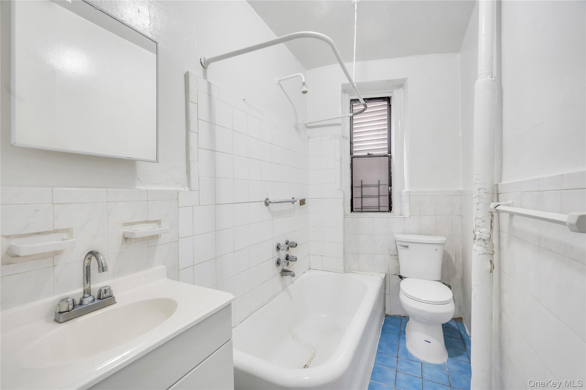 3152 Hull Avenue Bronx, NY 10467 - Photo 19 of 35 a bath room with a toilet a sink and a bath tub