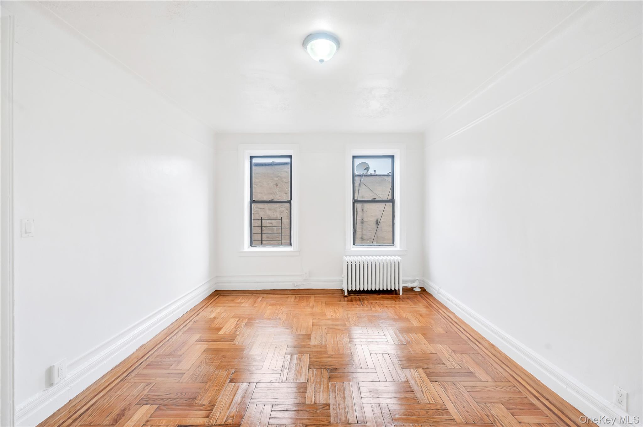 3152 Hull Avenue Bronx, NY 10467 - Photo 23 of 35 an empty room with wooden floor and windows