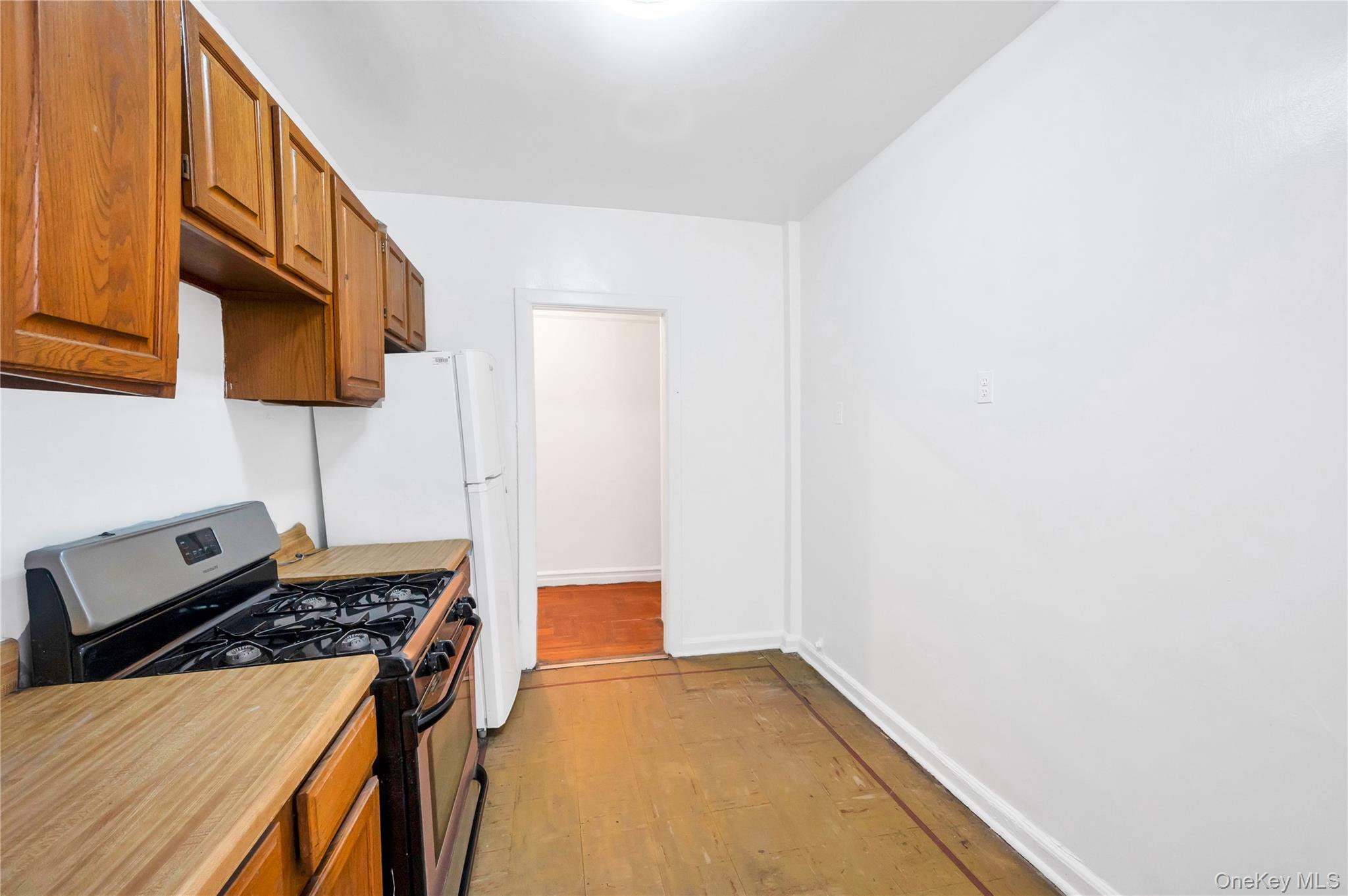 3152 Hull Avenue Bronx, NY 10467 - Photo 33 of 35 a kitchen with a stove and a white cabinet