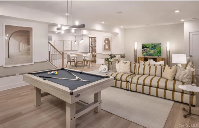 a living room with furniture a chandelier and a flat screen tv