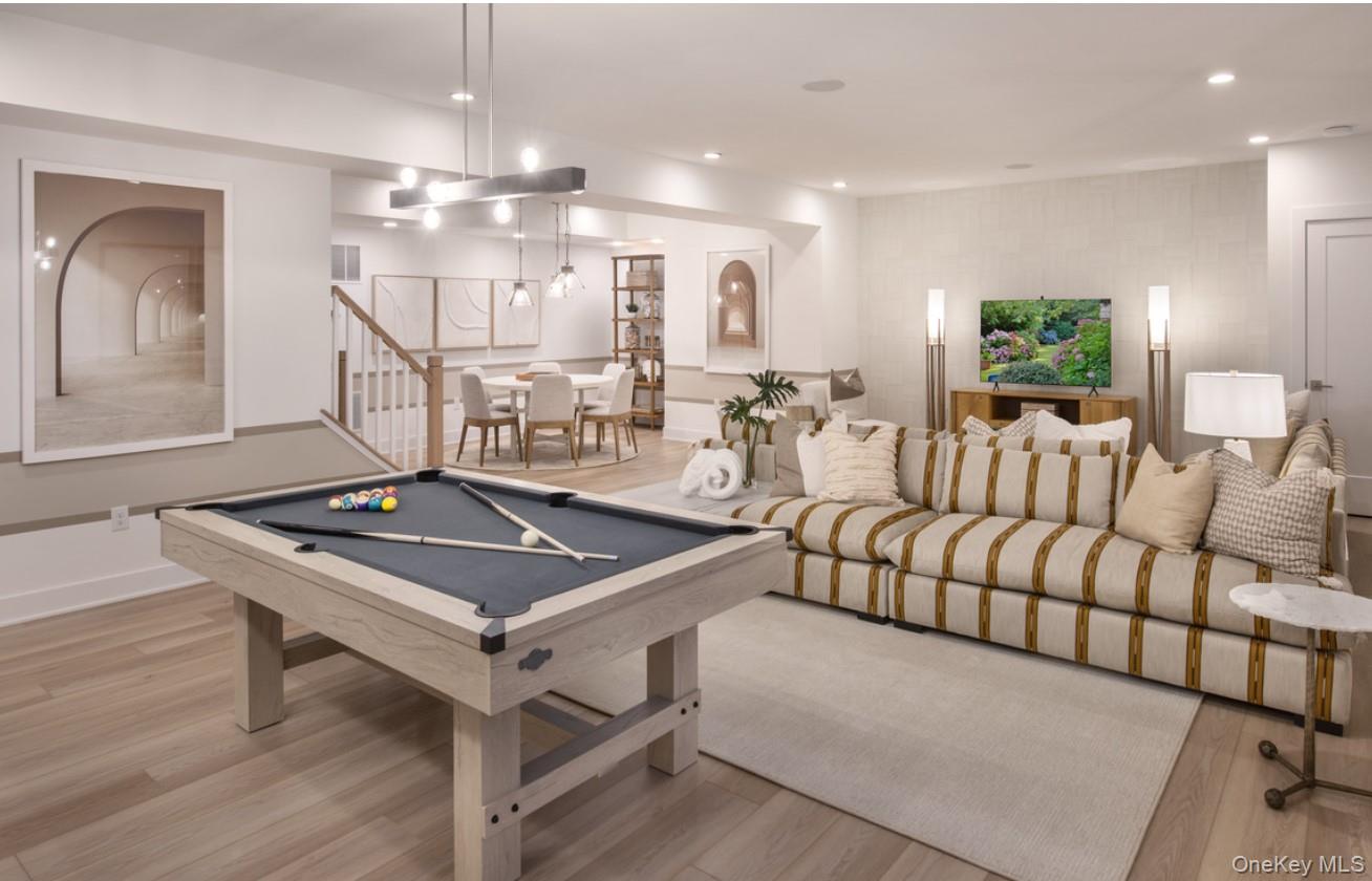 5 Fieldstone Knoll, Unit 45 Armonk, NY 10504 - Photo 11 of 17 a living room with furniture a chandelier and a flat screen tv