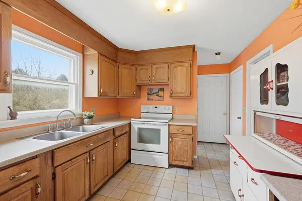 a kitchen with a stove sink and cabinets