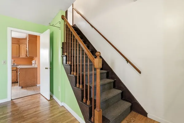 a view of staircase with wooden floor and stairs