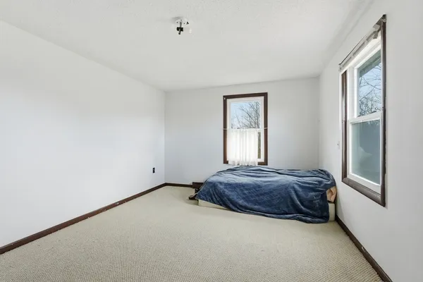 a living room with a bed and a window