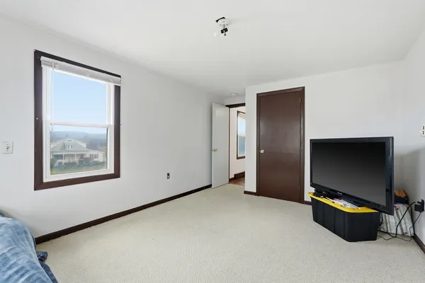 a living room with window and a flat screen tv