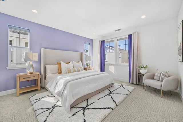 a spacious bedroom with a bed and a couch