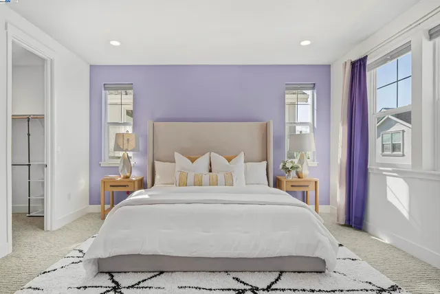 a bedroom with a large bed and a large window