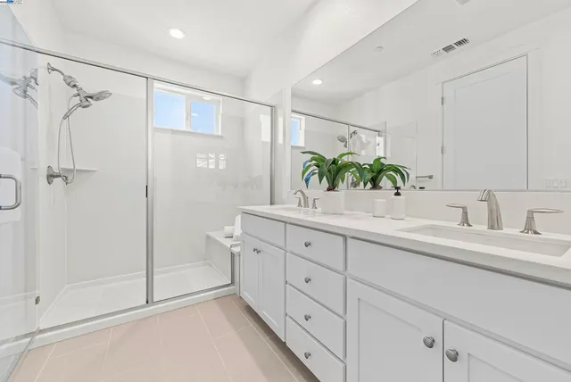 a bathroom with a shower sink and mirror
