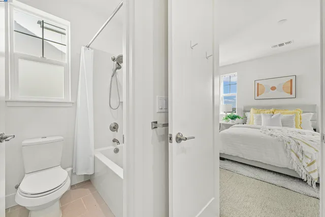 a bathroom with a granite countertop toilet a sink and a shower