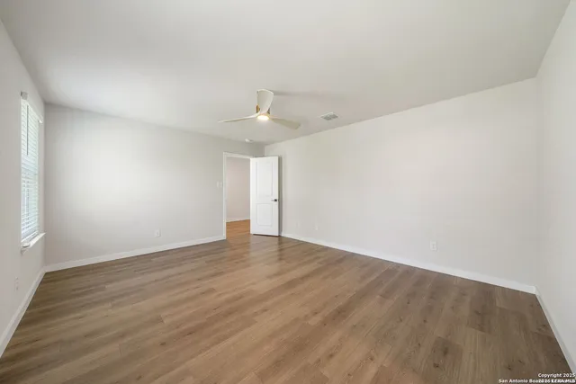 a view of an empty room with wooden floor