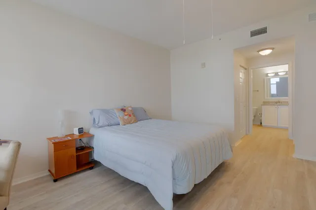 a bedroom with a bed and a chair