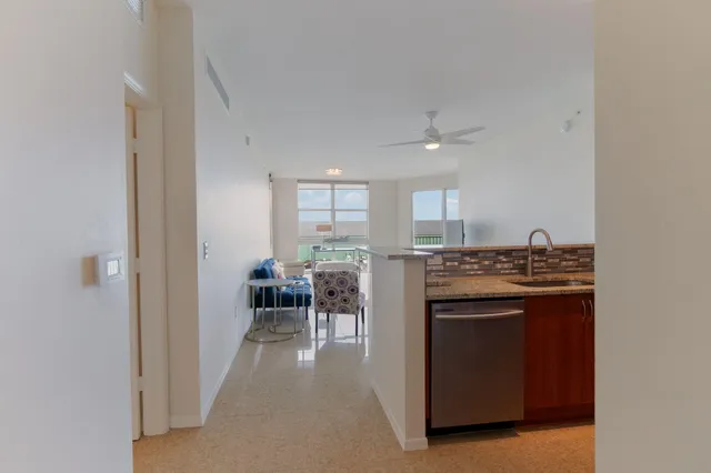 a kitchen with kitchen island a stove and a sink