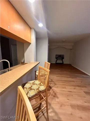 a view of an empty room and wooden floor