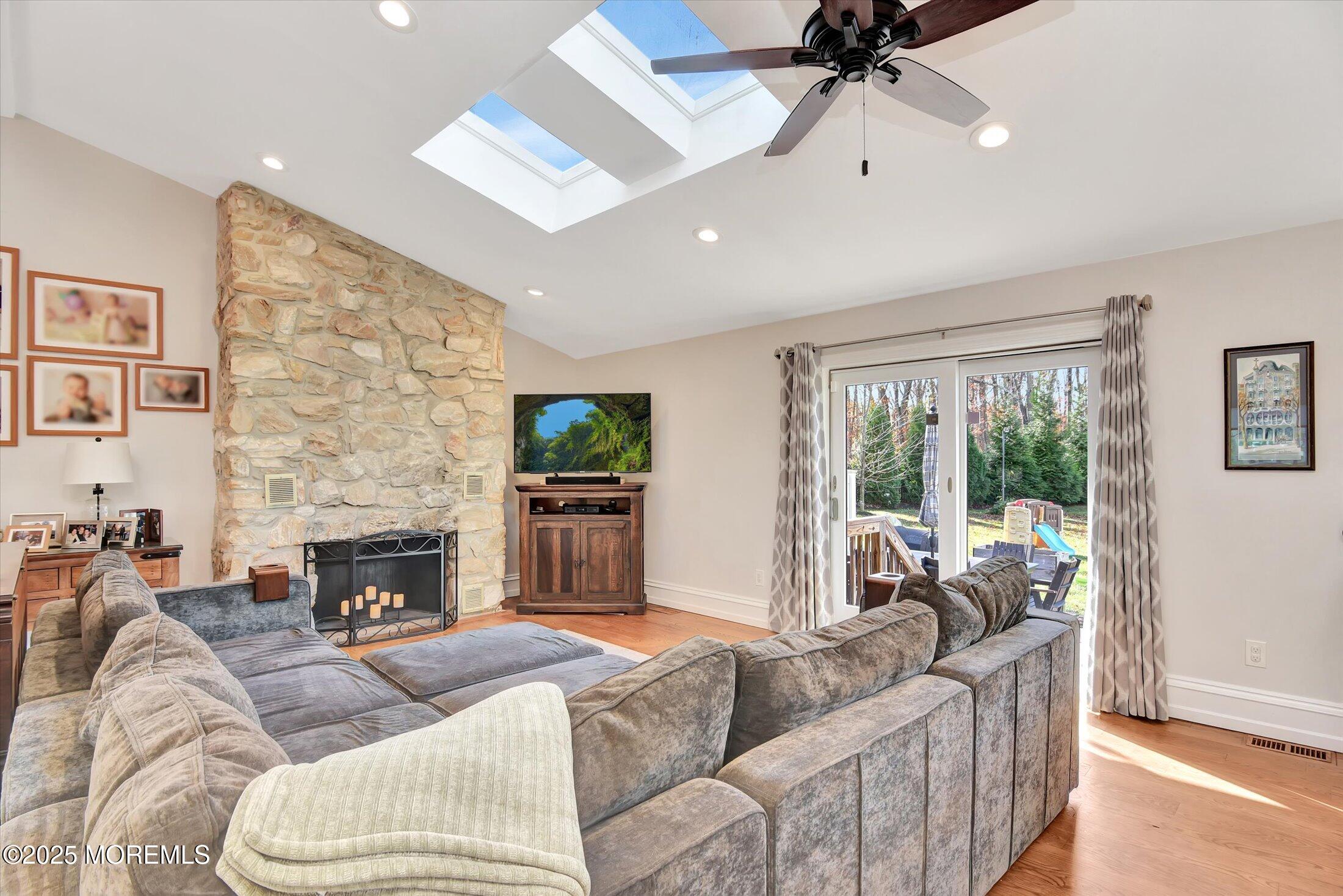 2 Lyndon Lane Howell, NJ 07731 - Photo 11 of 51 a living room with furniture a large window and a fireplace