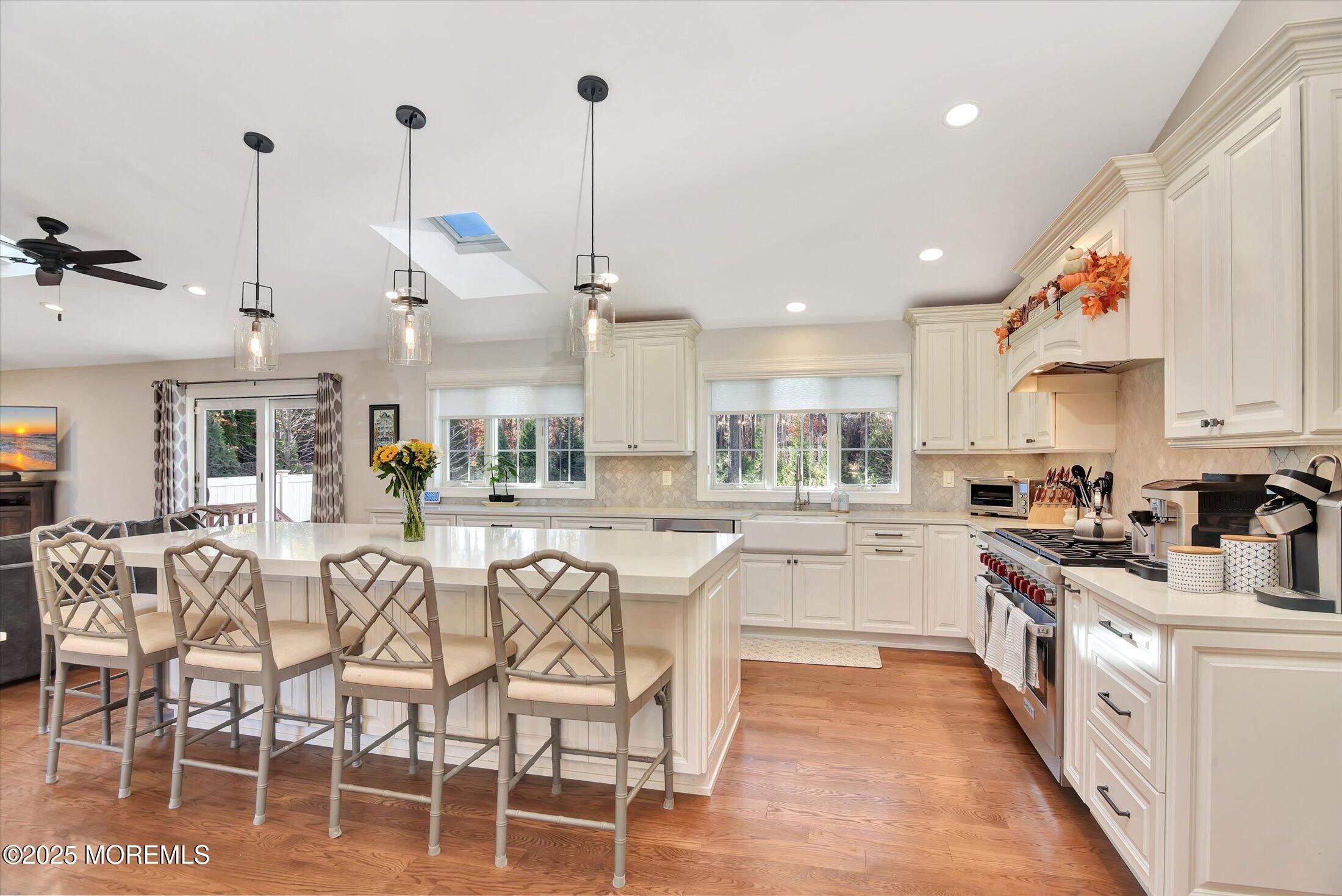 2 Lyndon Lane Howell, NJ 07731 - Photo 14 of 51 a kitchen with stainless steel appliances kitchen island granite countertop a table chairs sink and cabinets
