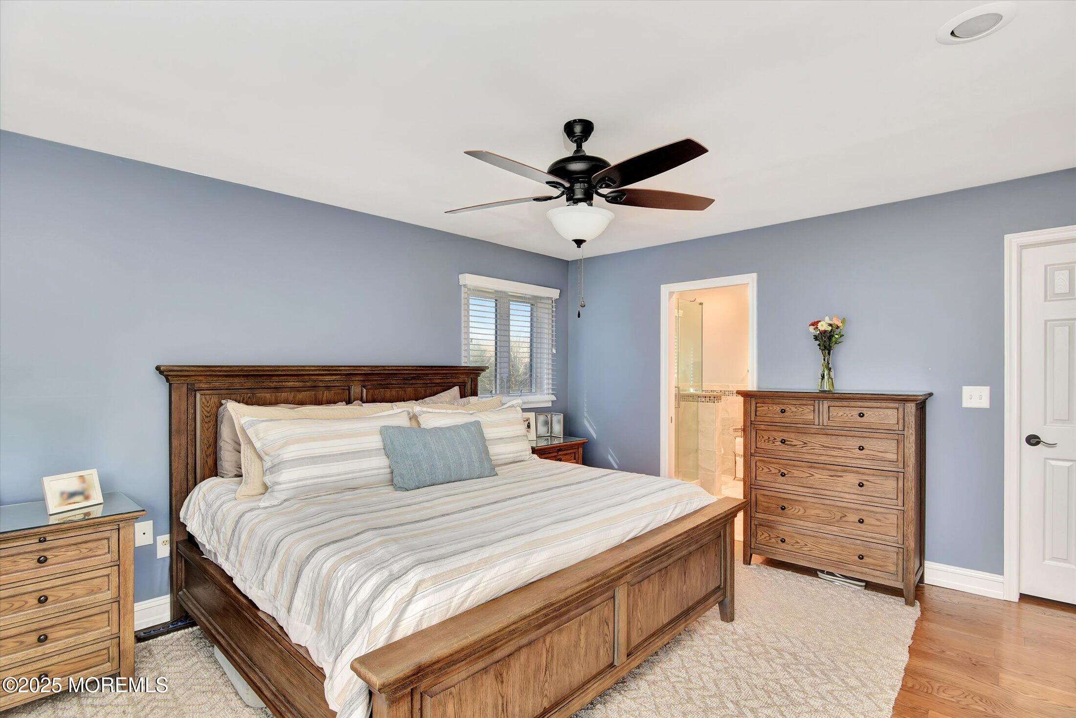 2 Lyndon Lane Howell, NJ 07731 - Photo 26 of 51 a bedroom with a bed and a chandelier