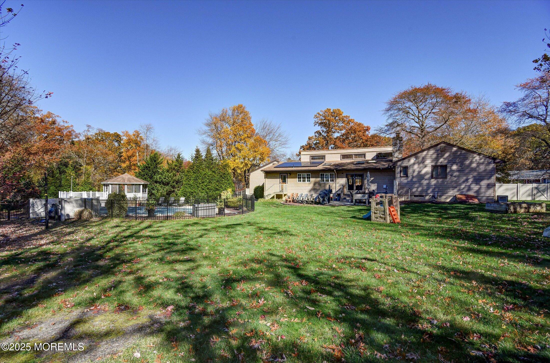 2 Lyndon Lane Howell, NJ 07731 - Photo 50 of 51 a view of a big house with a big yard plants and large trees