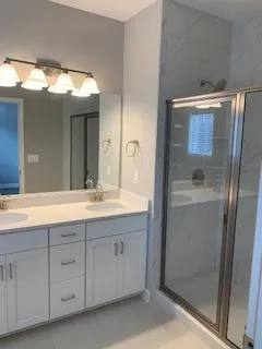 a bathroom with a double vanity sink and mirror