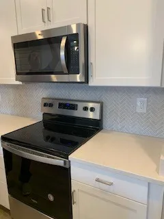 a kitchen with a stove and a microwave