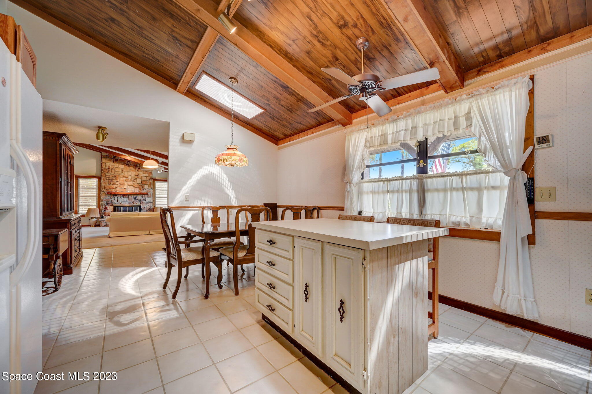 1250 Faulkingham Road Merritt Island, FL 32952 - Photo 4 of 10 a kitchen with a stove a table and chairs