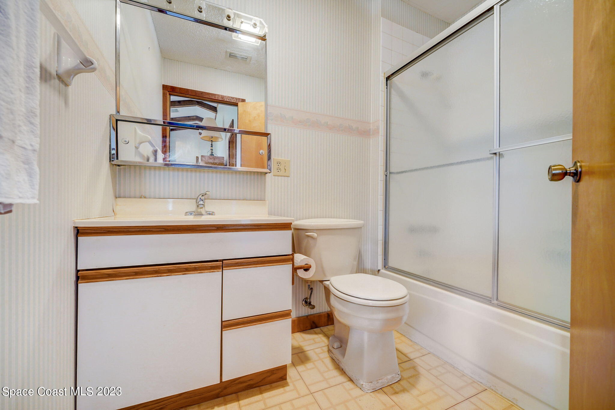 1250 Faulkingham Road Merritt Island, FL 32952 - Photo 5 of 10 a bathroom with a toilet sink and mirror