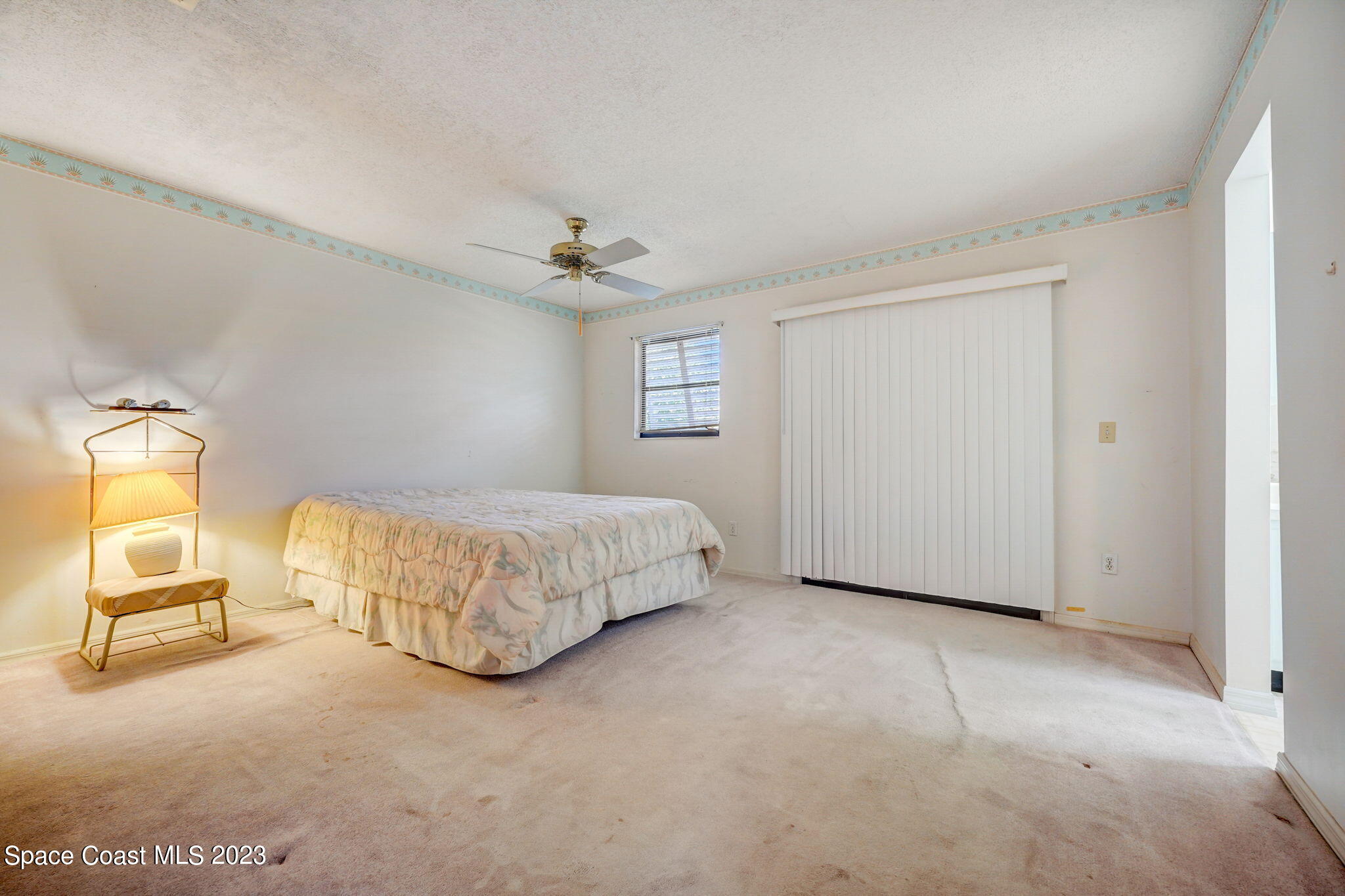 1250 Faulkingham Road Merritt Island, FL 32952 - Photo 7 of 10 a bedroom with a bed and a chair