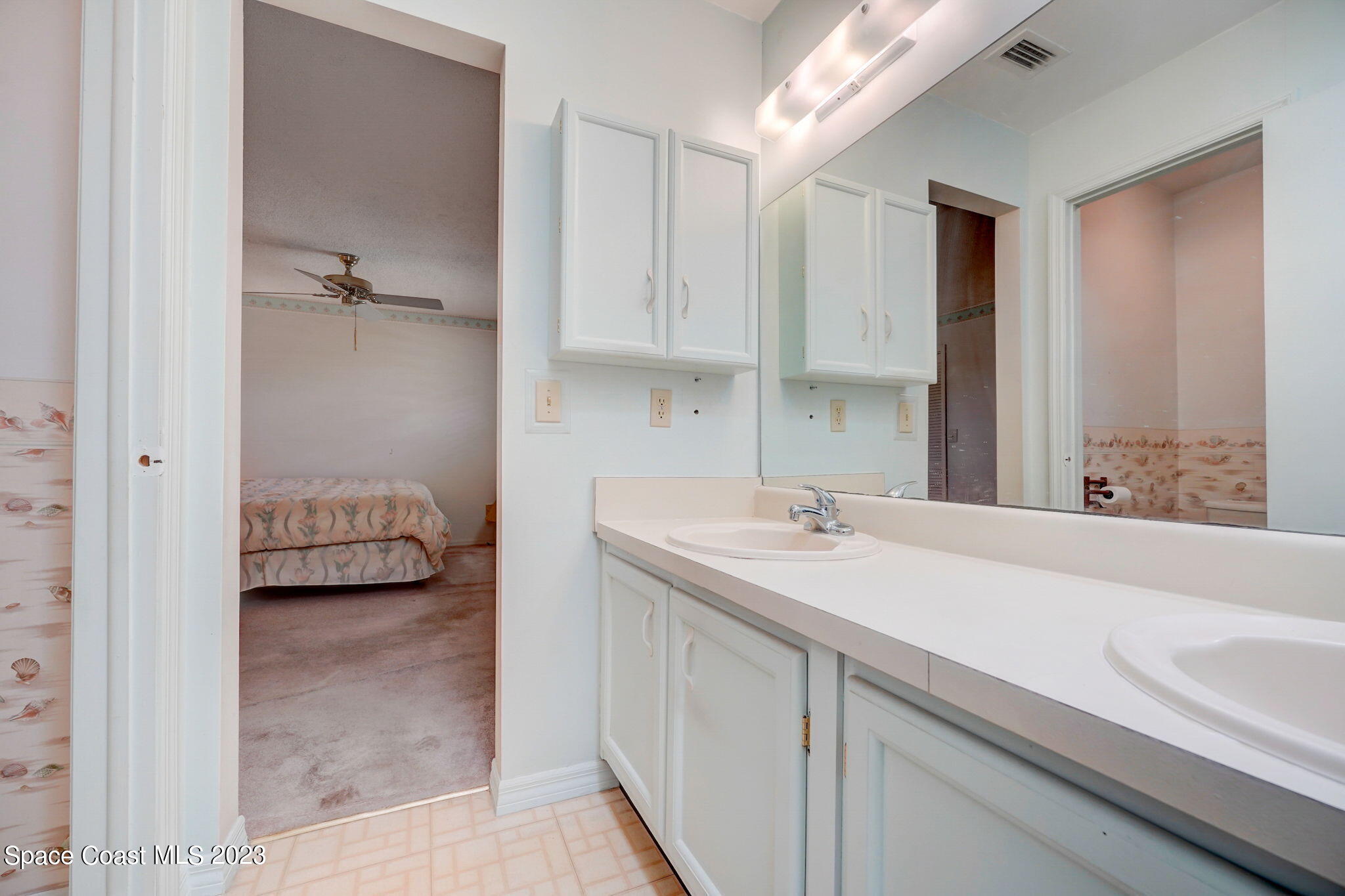 1250 Faulkingham Road Merritt Island, FL 32952 - Photo 8 of 10 a en suite bathroom with a sink and a mirror